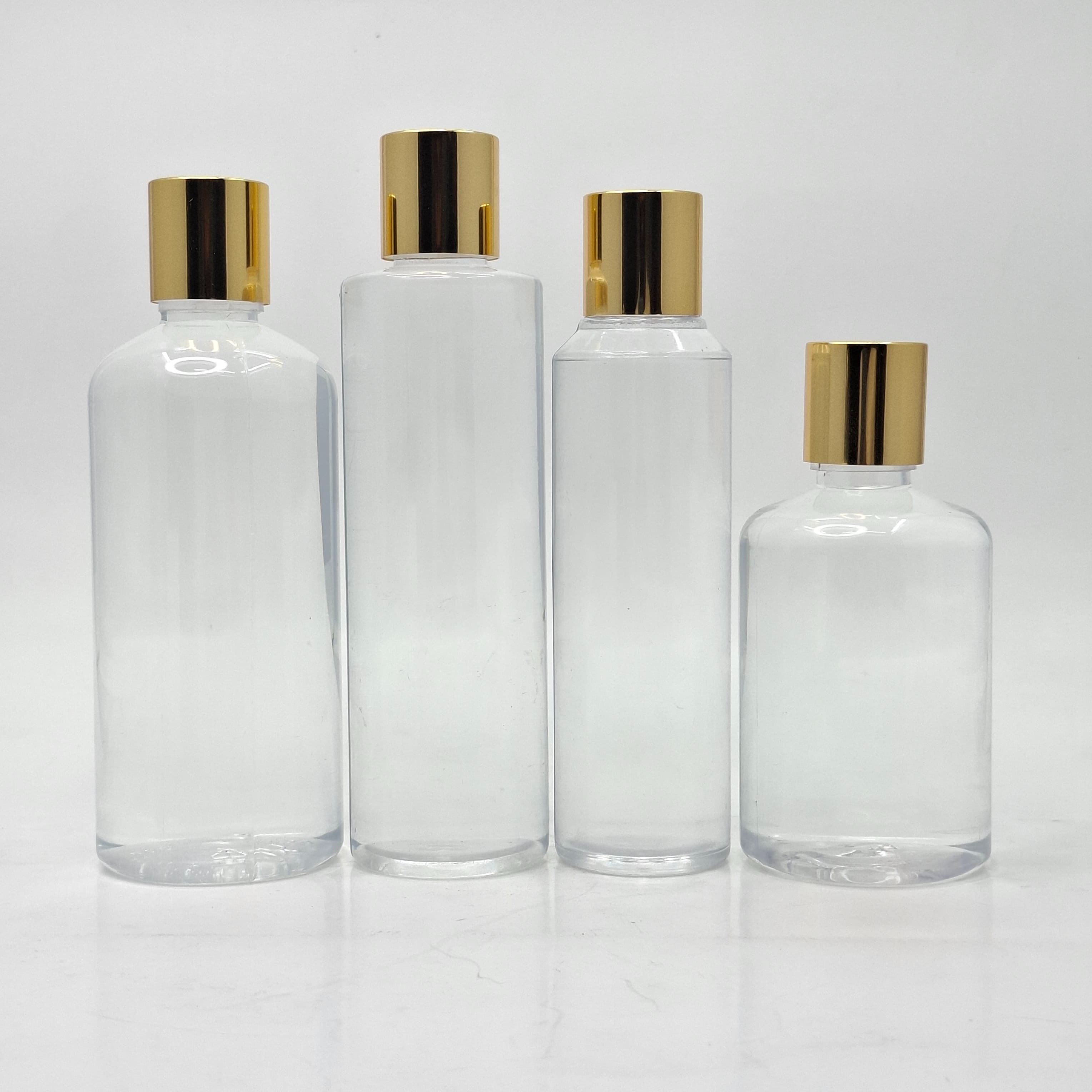Main image of Round Clear Bottle - Press Cap Gold