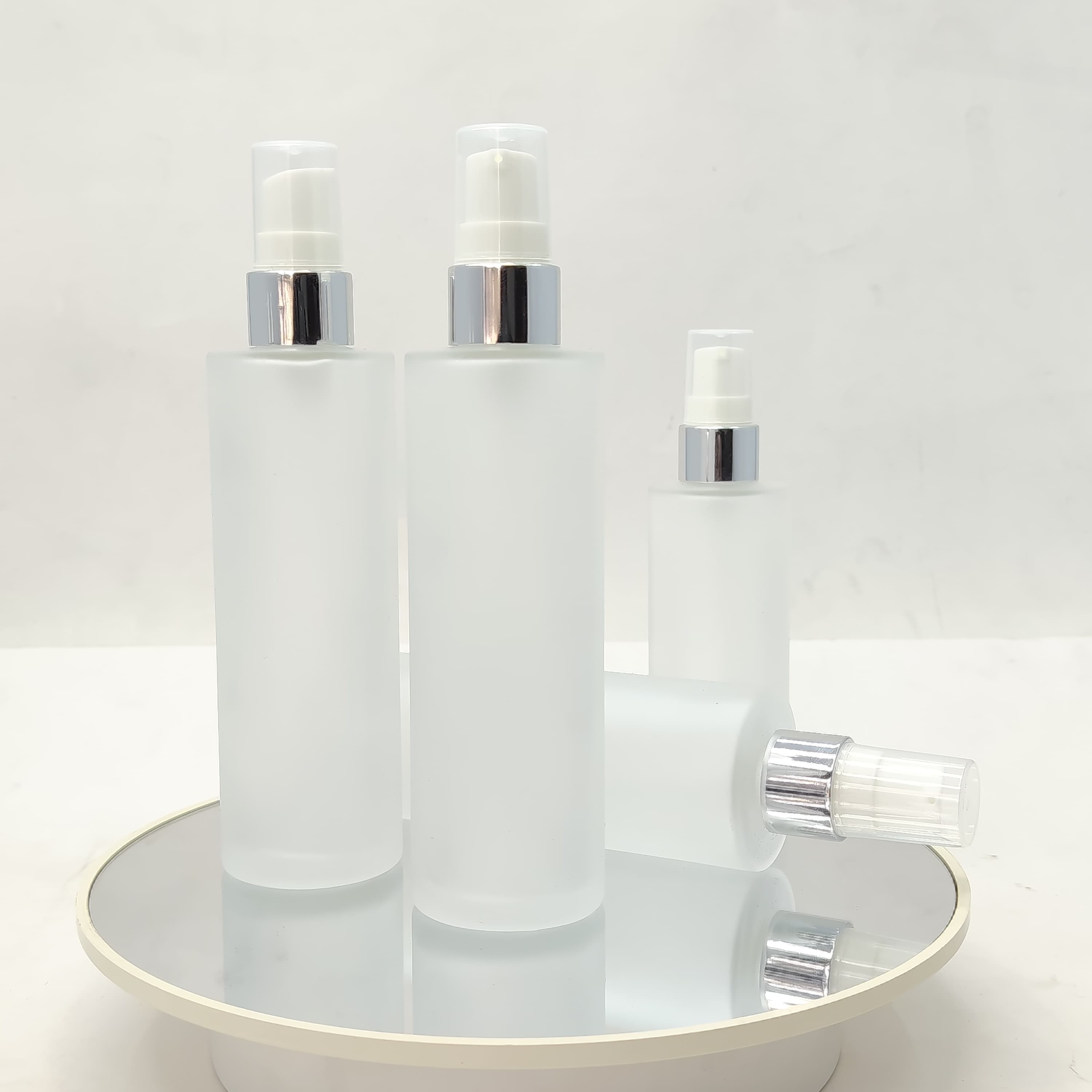 Main image of 100ml Frosted Glass Bottle - Silver Drop Pump 