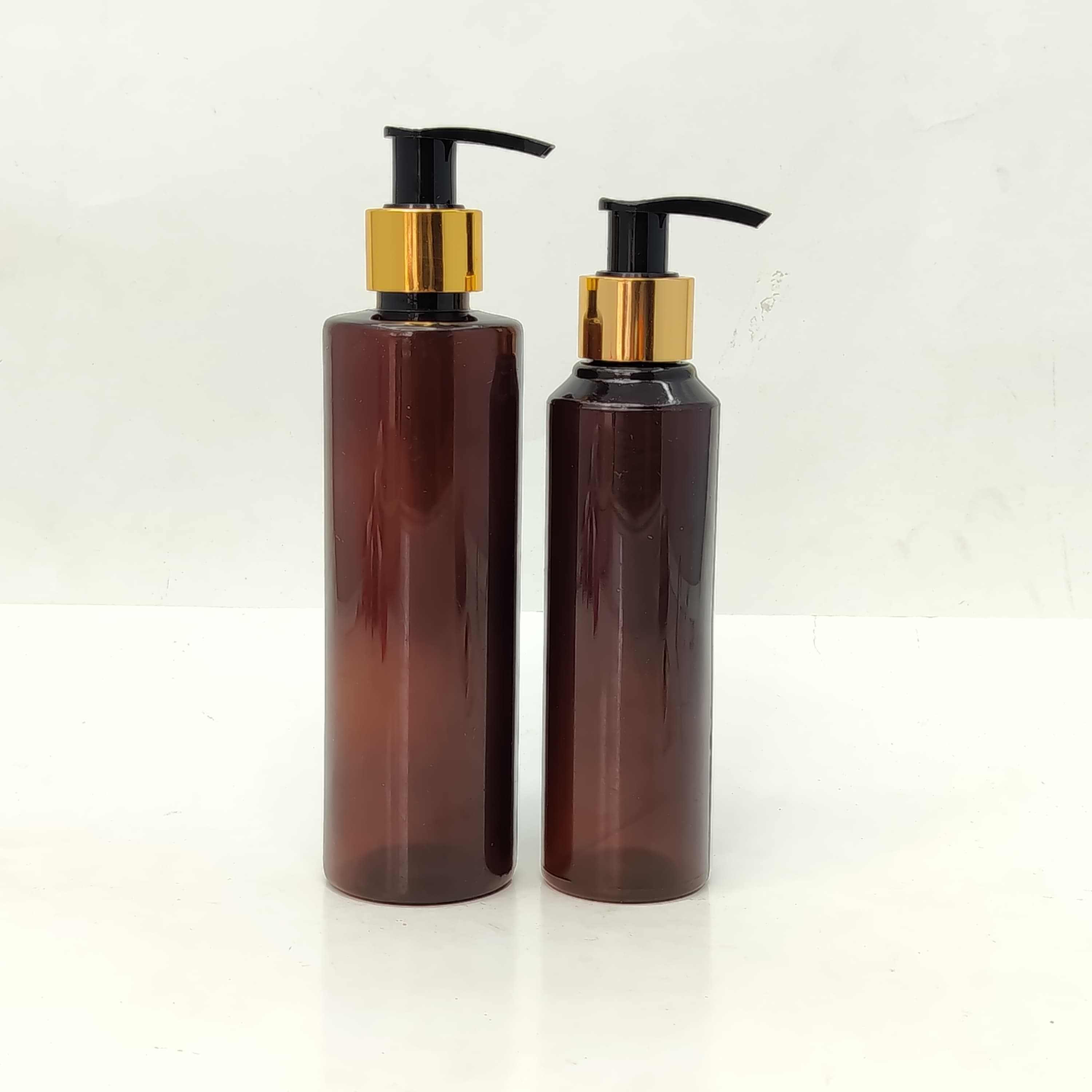 Main image of 150ml-200ml Round Amber Bottle - Gold Black Pump