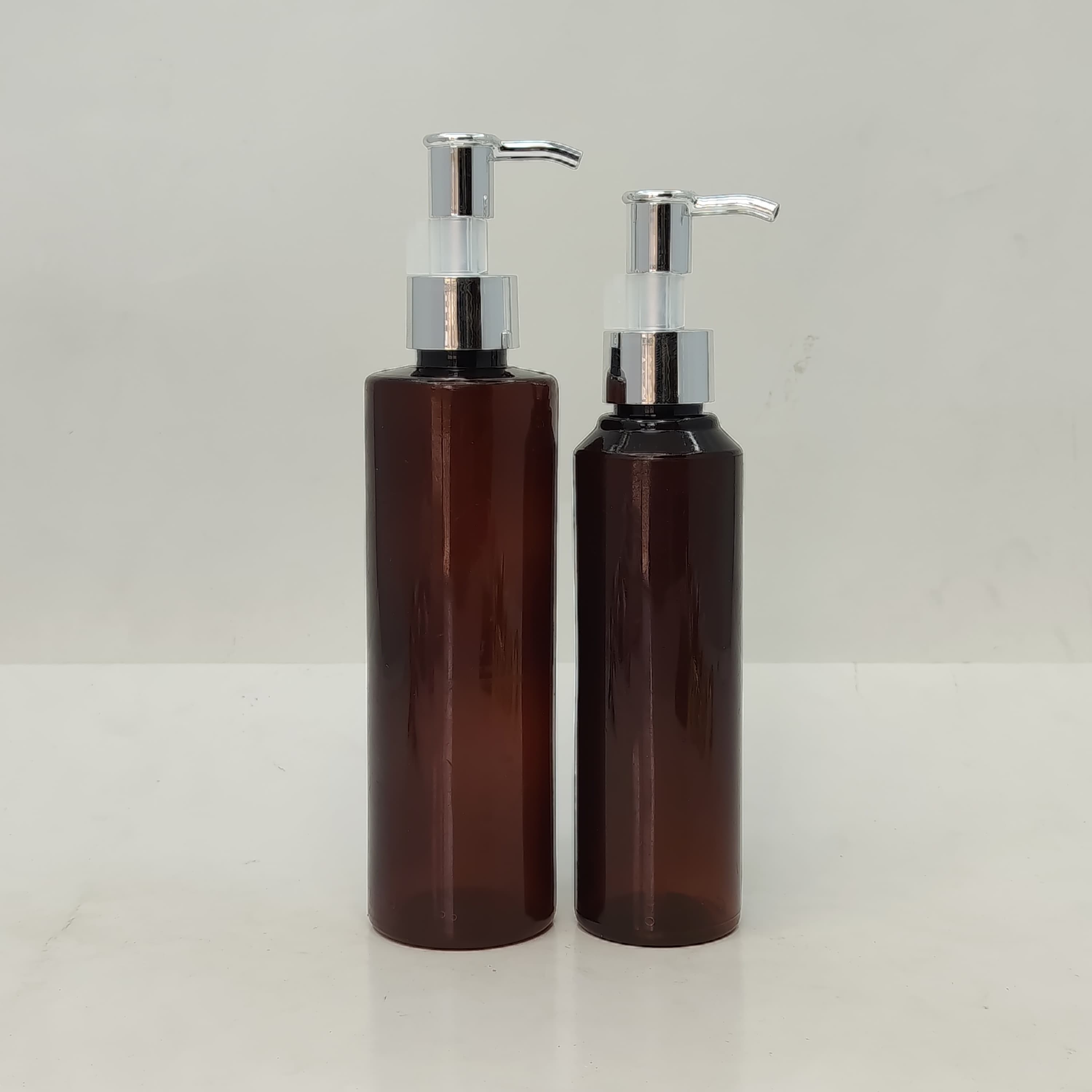 Main image of 150ml-200ml Round Amber Bottle - Silver Pump-Long Neck