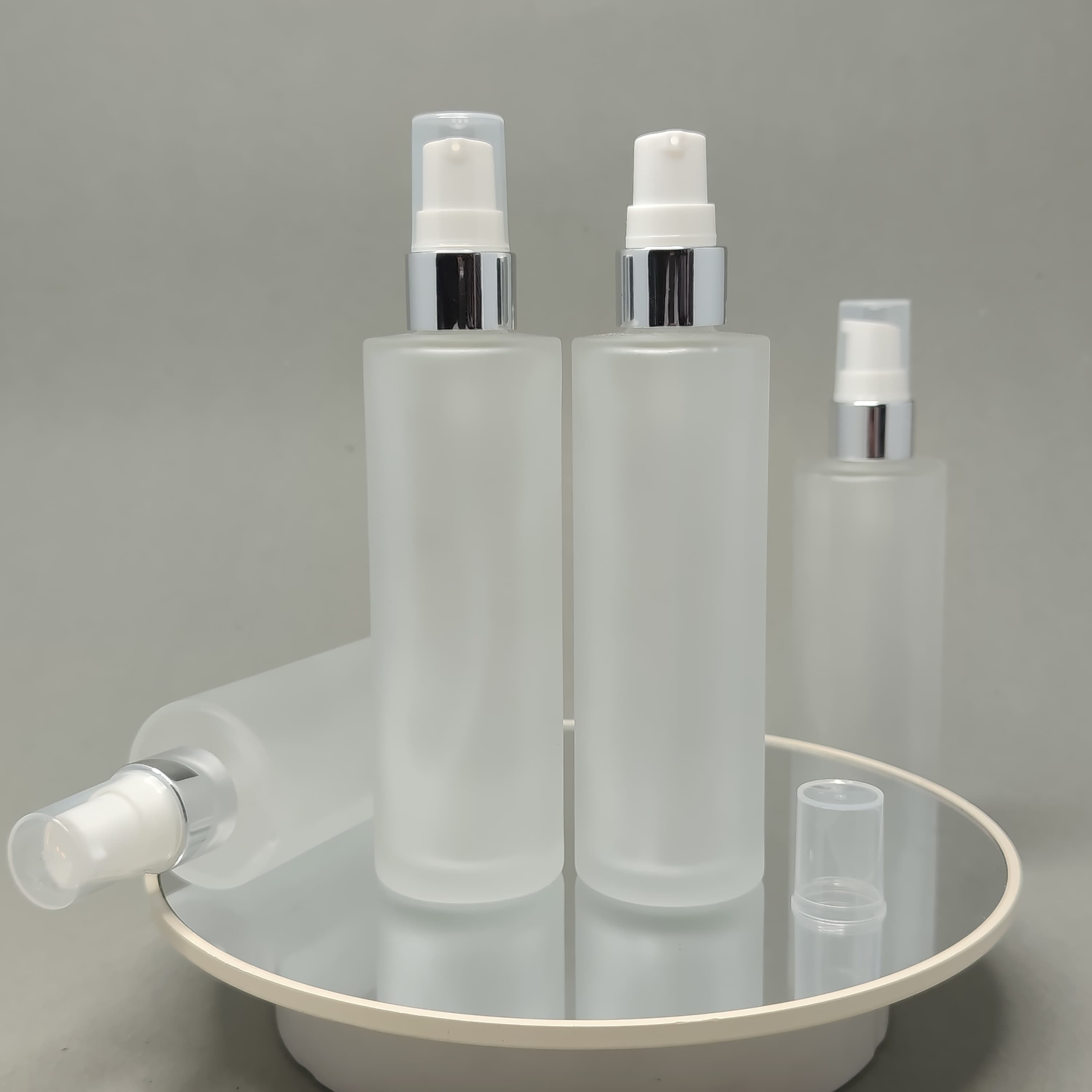 Main image of 100ml Frosted Glass Bottle - Silver Drop Pump 
